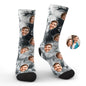 Worn personalised tie-dye photo face socks peeking from trainers, showcasing a playful custom photo print — perfect novelty gift