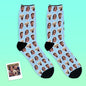Two personalised face socks displayed as a pair against a contrasting background to highlight face cutouts and colour vibrancy