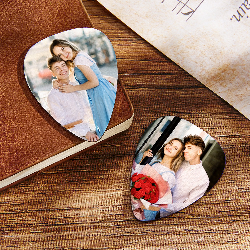Close-up of a personalised guitar pick with custom text engraving example — name and short quote on a plastic custom guitar pick