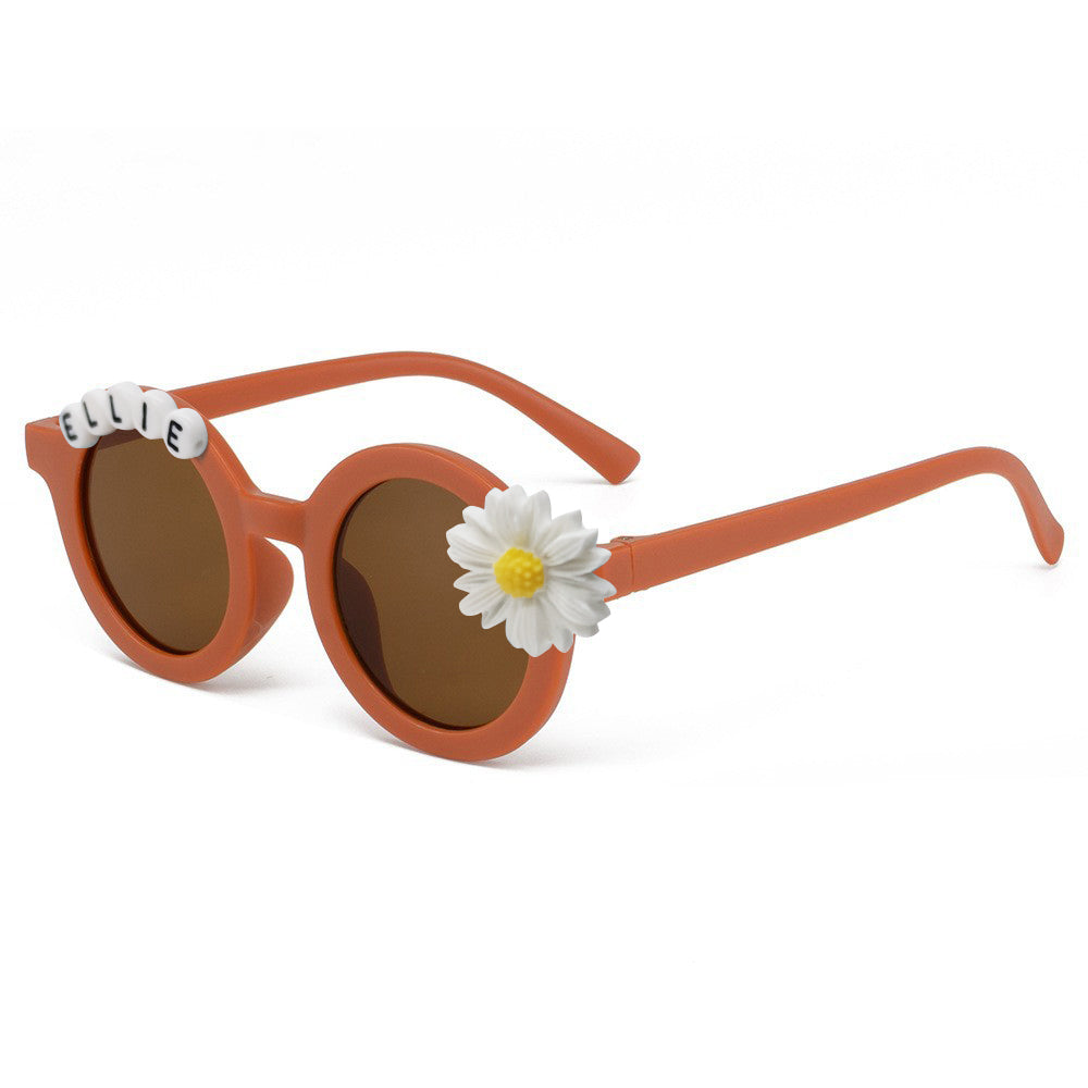 Side profile of personalised daisy sunglasses showing sturdy hinge and temple — lightweight polycarbonate, impact‑resistant kids eyewear