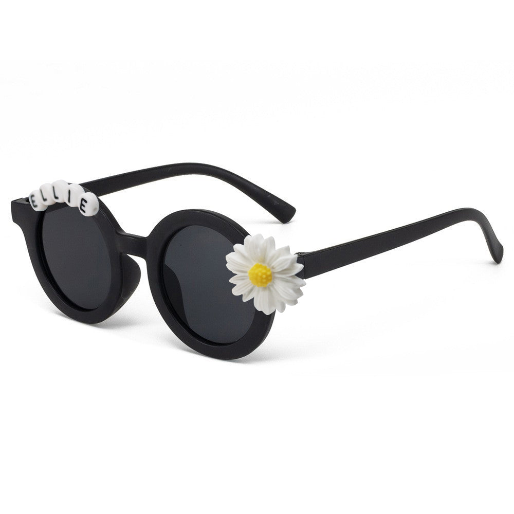 Gift presentation of personalised daisy sunglasses with custom name — cute party favour or thoughtful engraved gift for toddlers