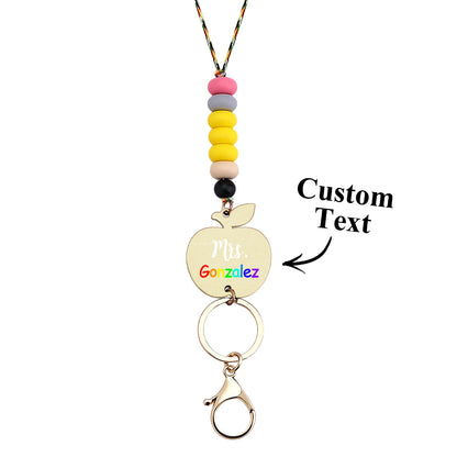 Personalised apple keychain attached to keys and lanyard — compact teacher key holder and ID pass accessory