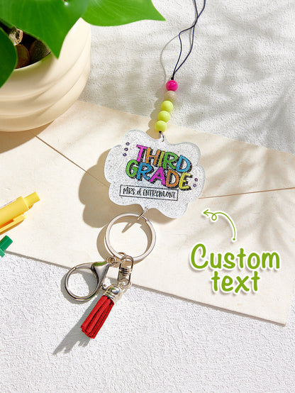 Tassel detail and bead gradient close-up on personalised acrylic beaded lanyard — glitter tassel lanyard feature