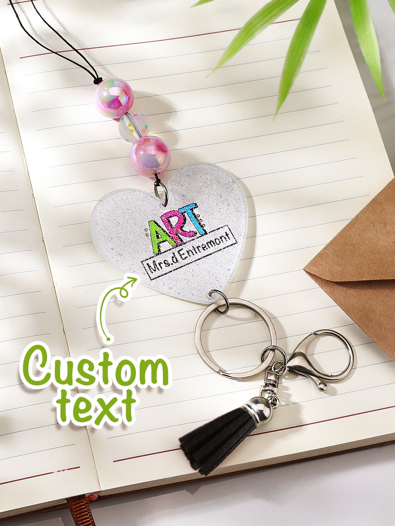 Personalised glitter lanyard draped over a notebook — perfect personalised teacher gift and everyday accessory