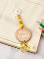 Close up of personalised name pendant on a bohemian lanyard showing clear custom text on a 5cm round card