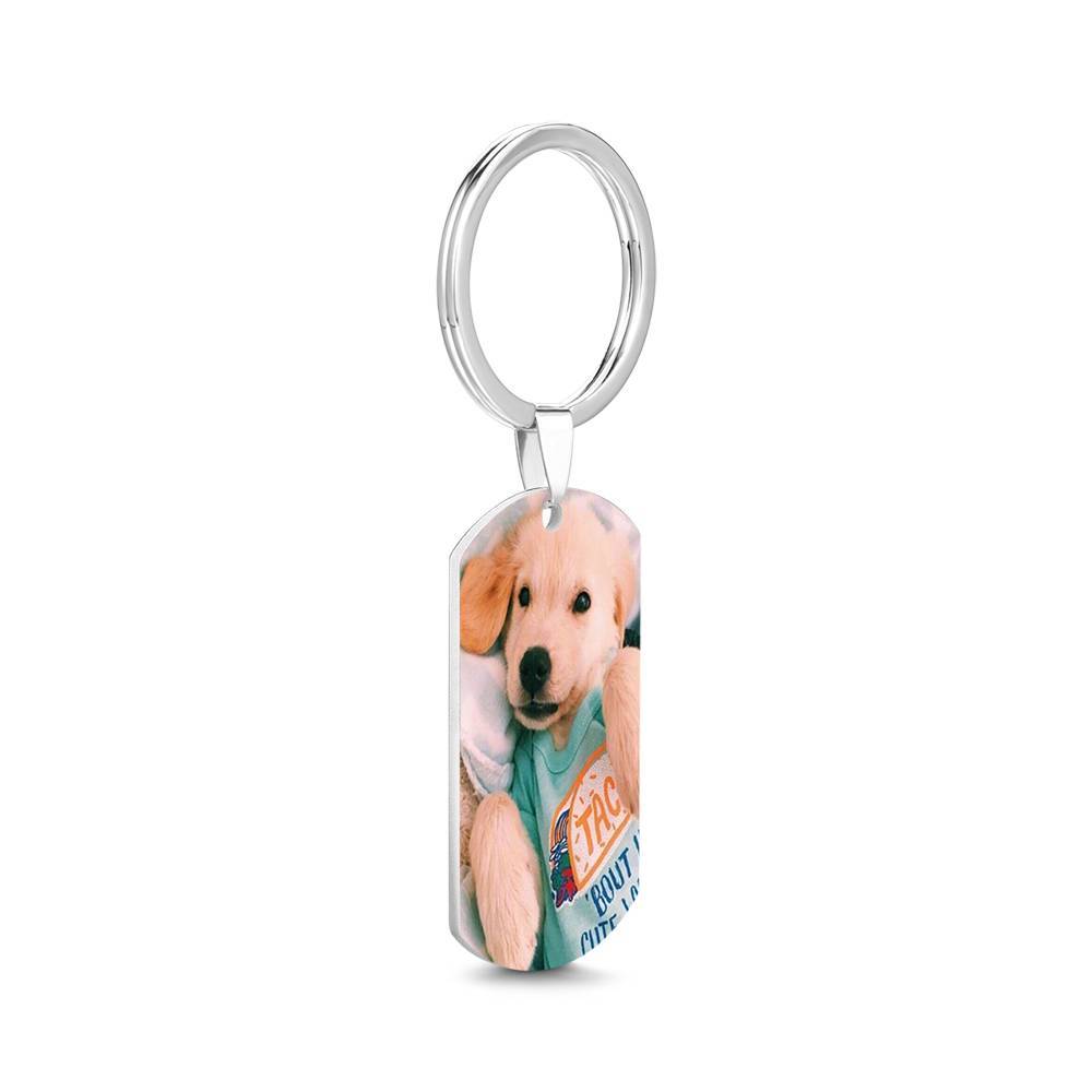 Personalised engraved stainless steel photo tag keychain — polished rectangular tag with a finely engraved photo and custom name hanging from a split key ring, studio close-up