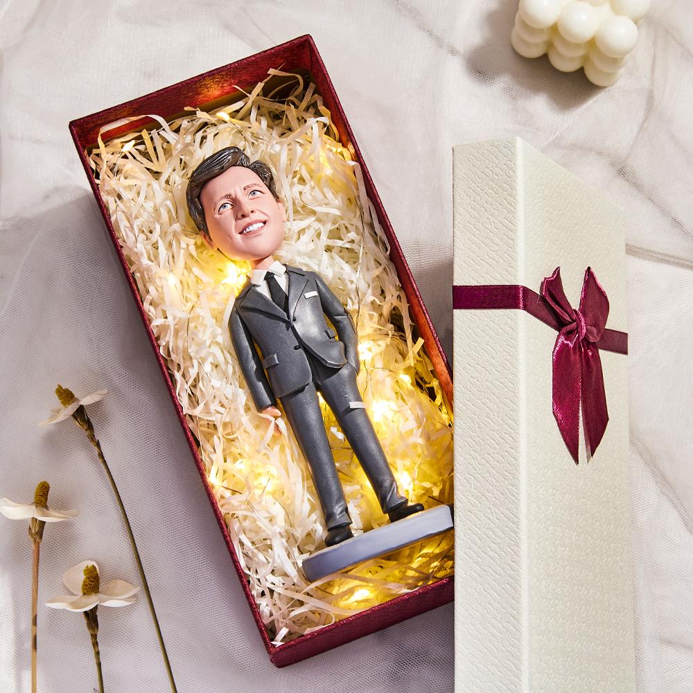 Close up of personalised head and hairstyle on a female executive bobblehead with engraved base, bespoke keepsake for colleagues and office awards