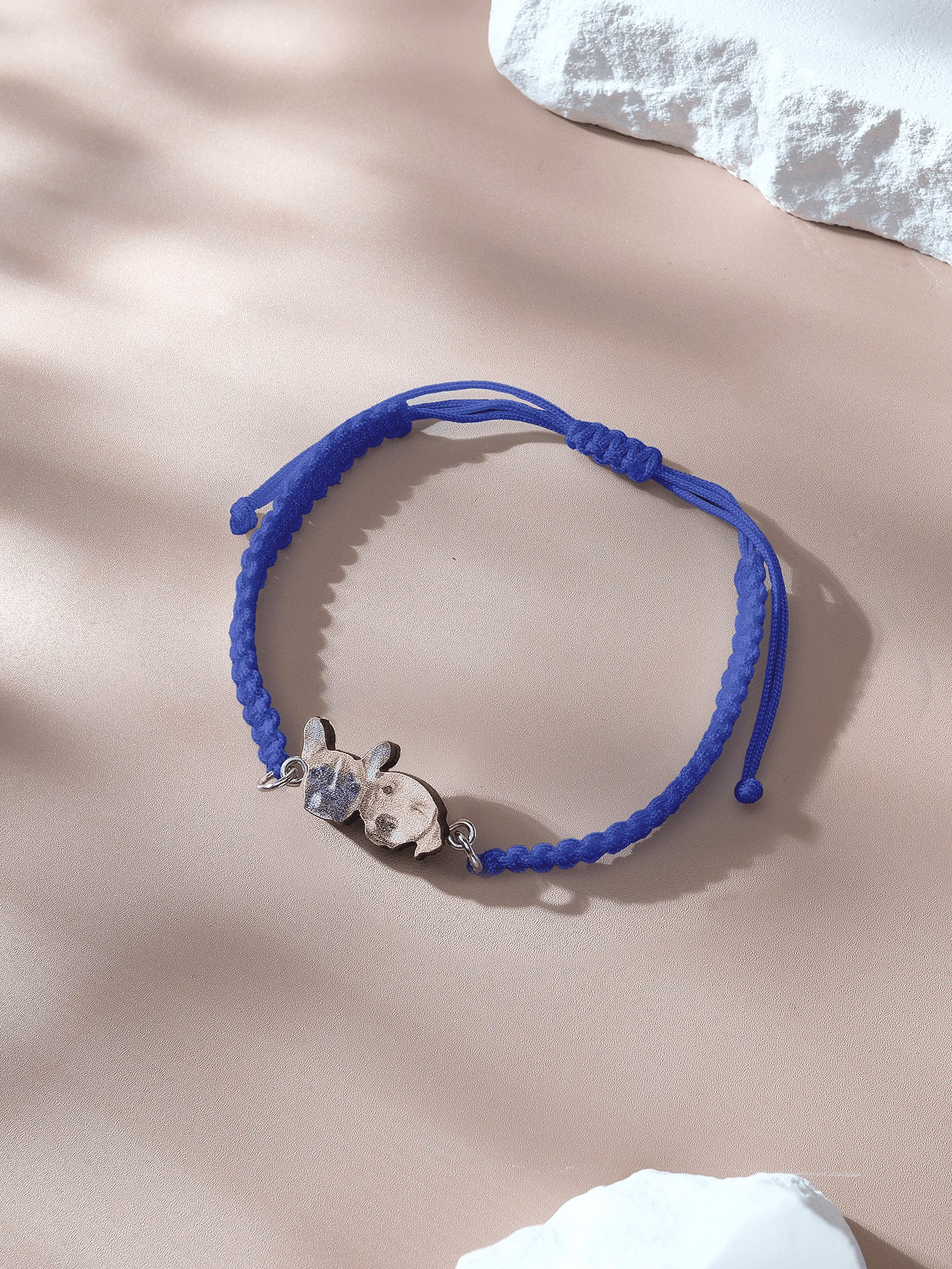 Macro shot of pendant featuring pet image on rope bracelet