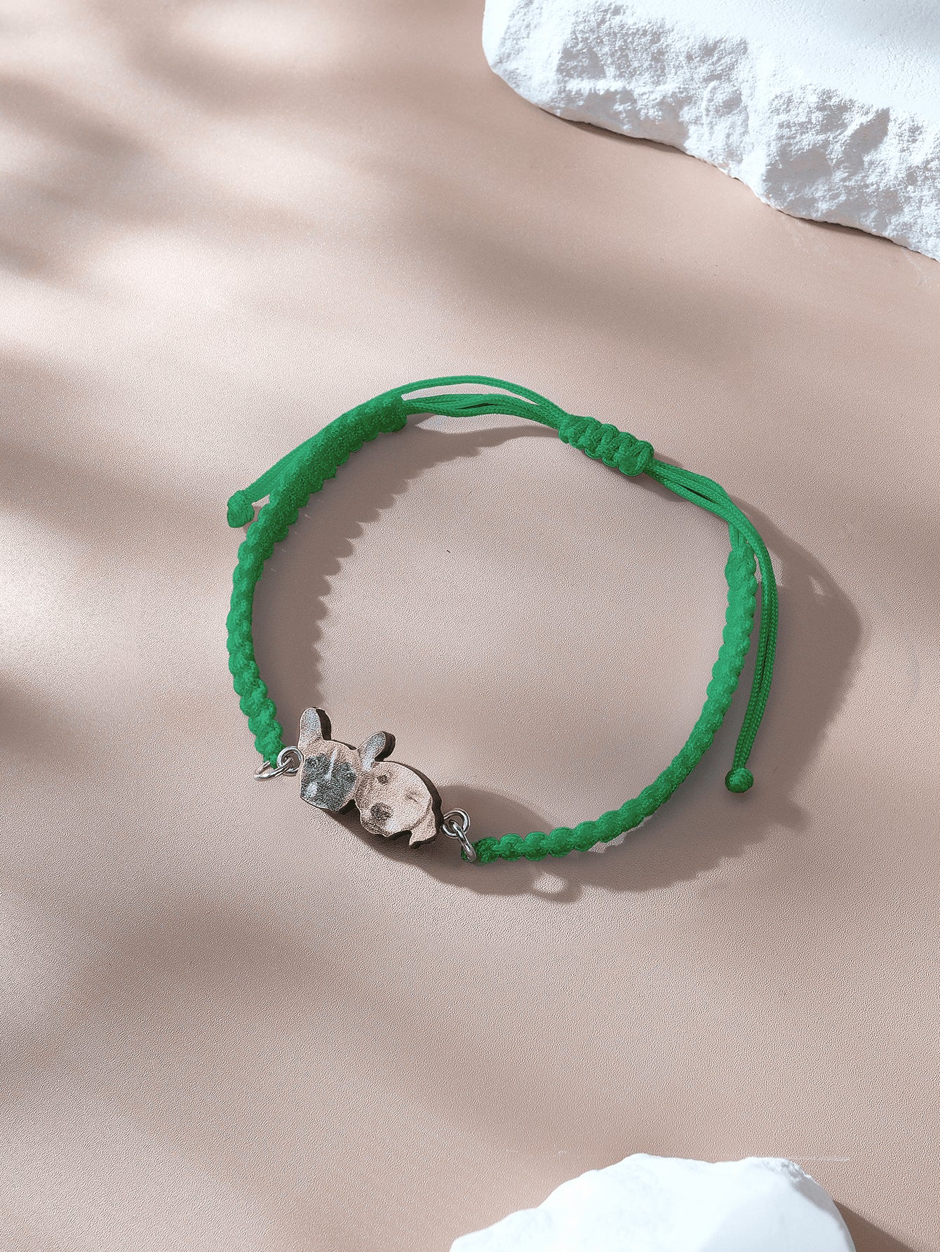 Side view of bracelet showing knot and pendant