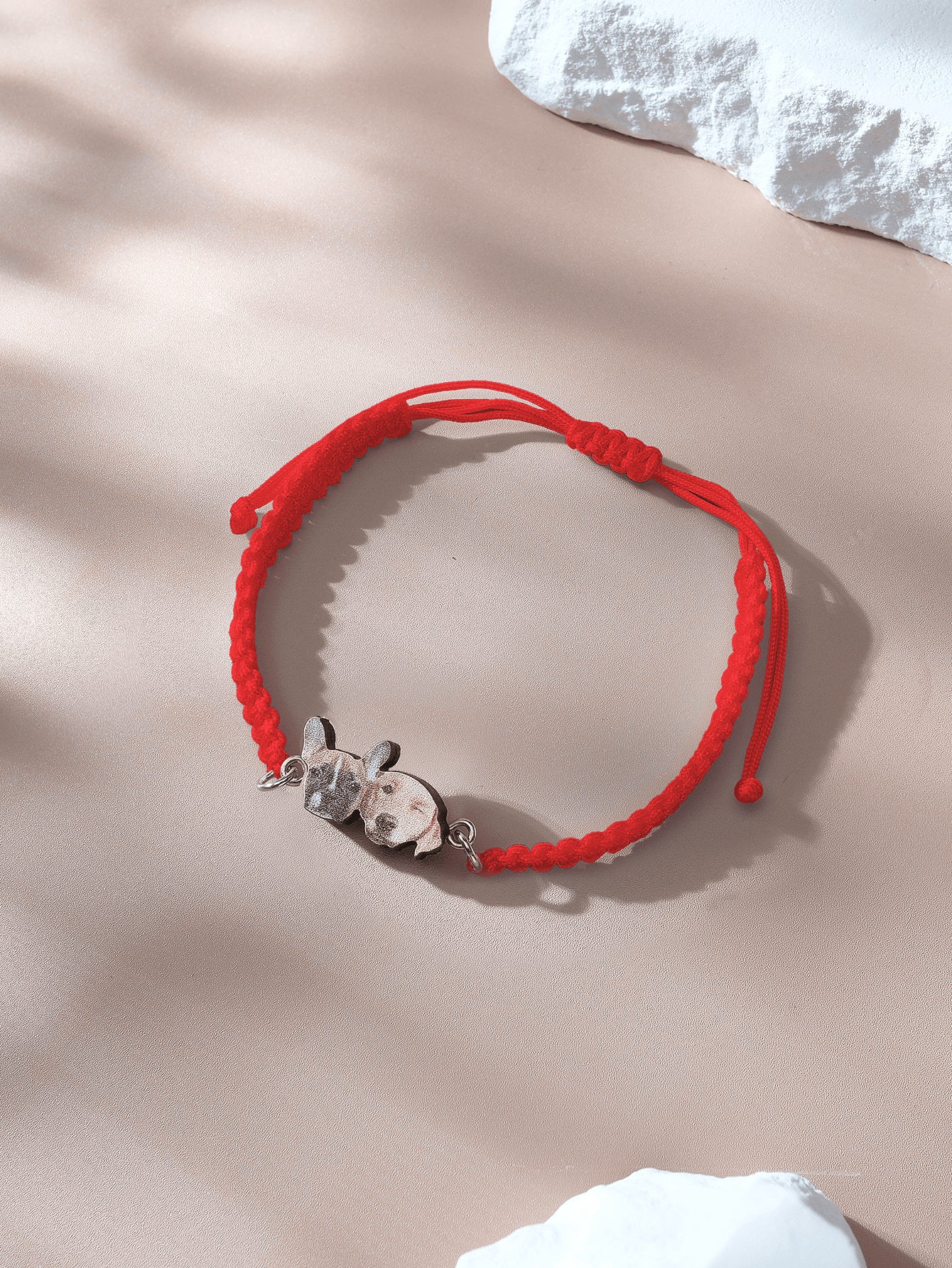Wooden pendant close up featuring pet portrait on bracelet