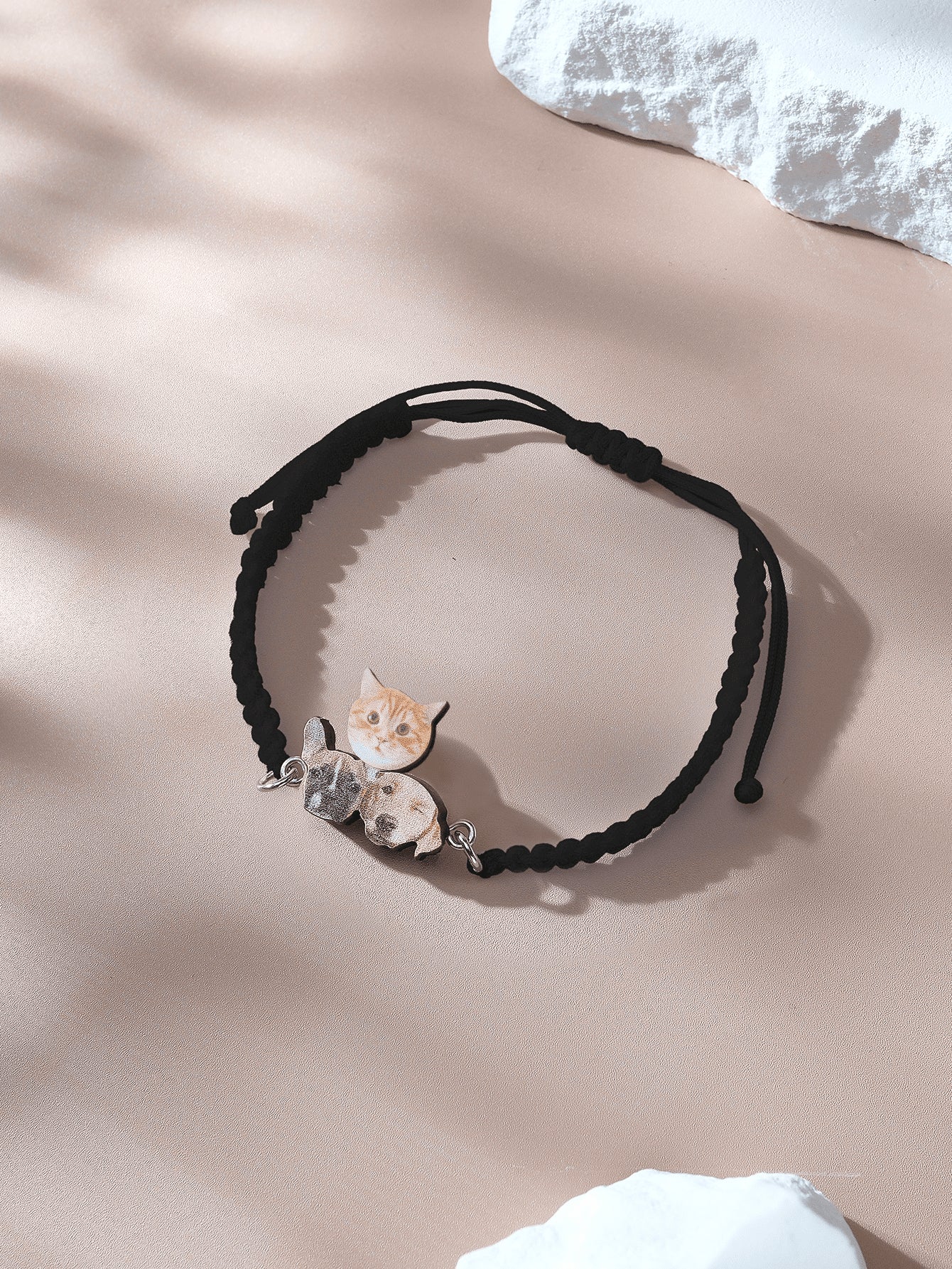Bracelet laid flat showcasing wooden pendant and adjustable rope