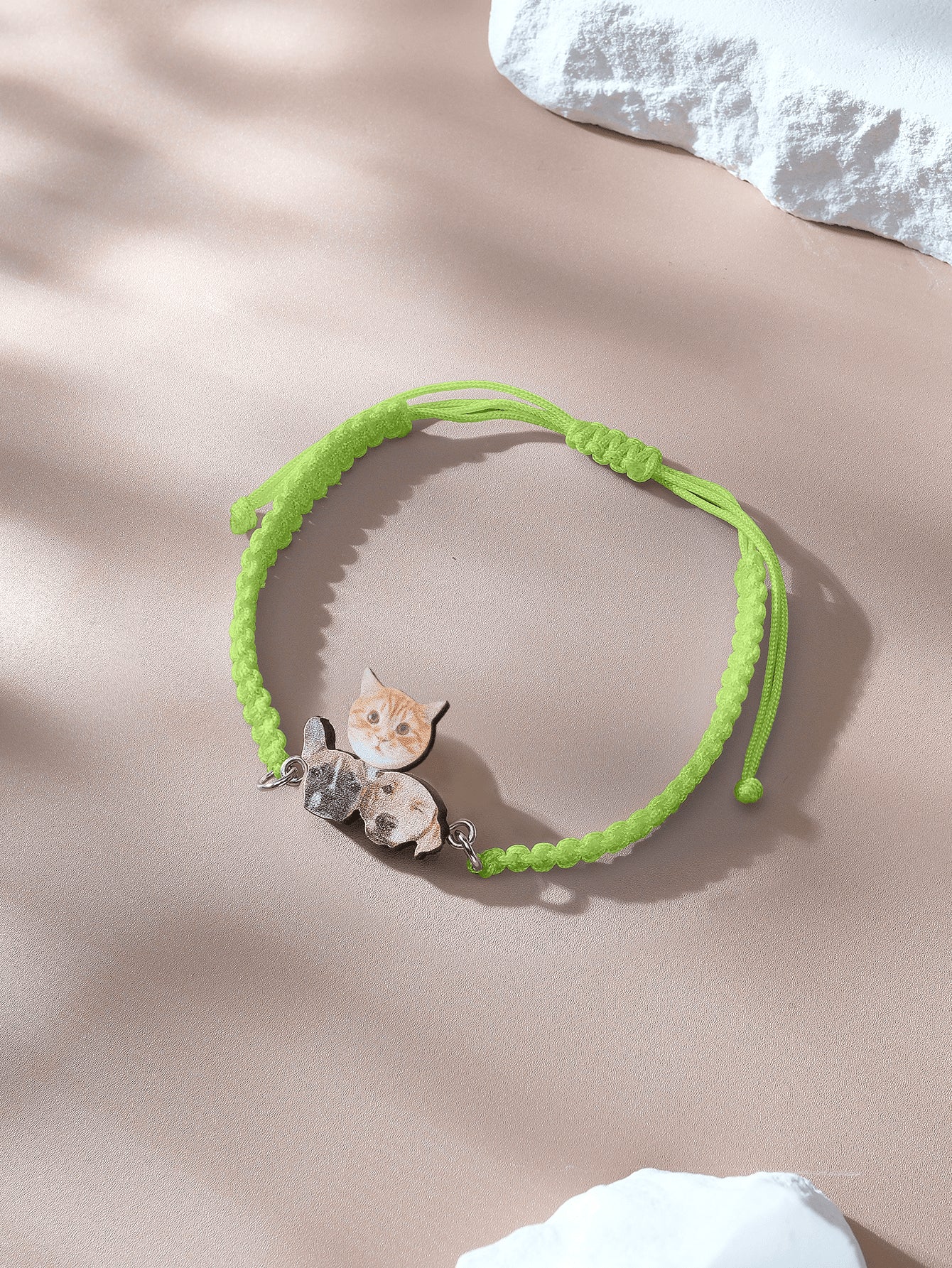 Close up of wooden charm showing pet portrait on bracelet