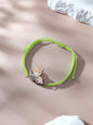 Close up of wooden charm showing pet portrait on bracelet