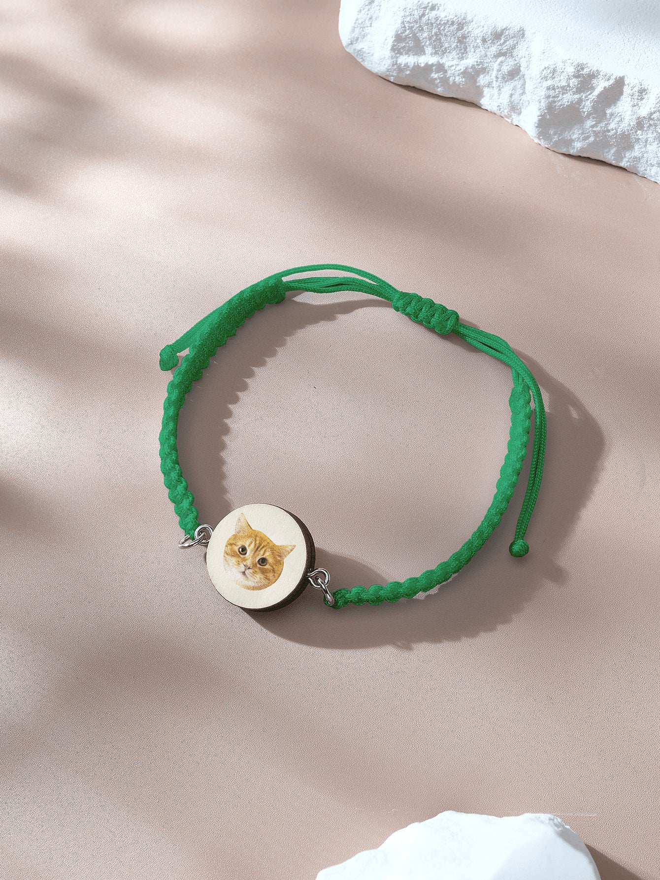 Close up of pendant and cord texture on bracelet