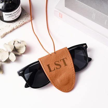 Macro shot of personalised initials engraved on leather travel glasses lanyard – crisp engraving detail