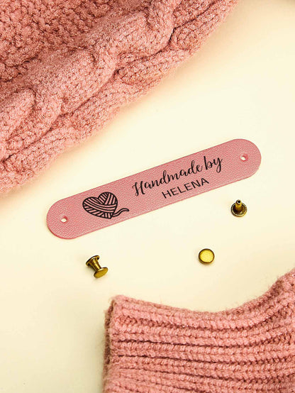 Custom PVC labels featuring engraved-style text ideal for knitted hats and scarves