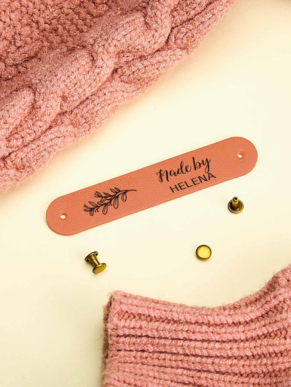 Personalised PVC tag shown on a handmade scarf for a professional finishing touch