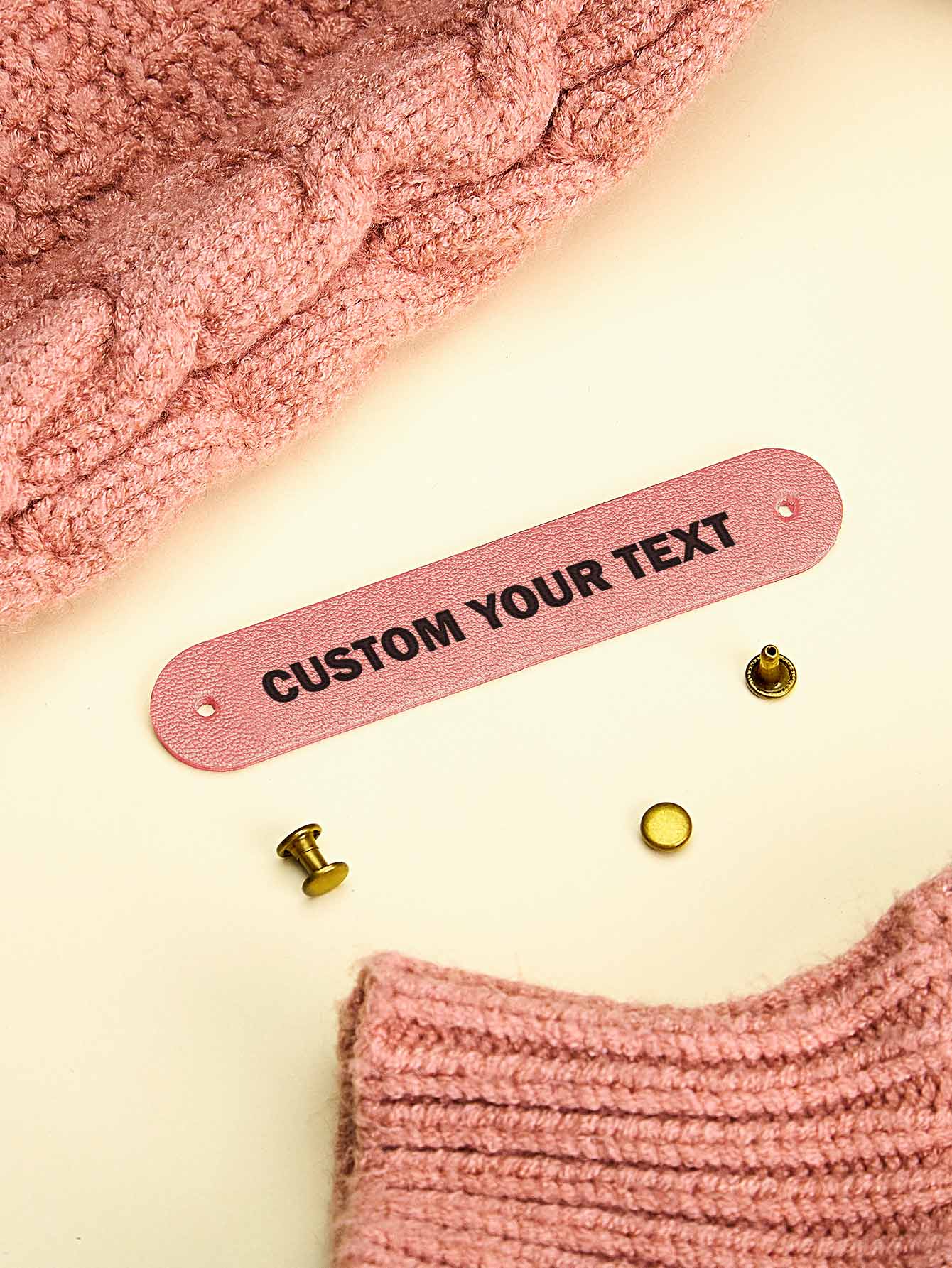 Personalised PVC labels in neutral tones — subtle branding for handmade knitwear
