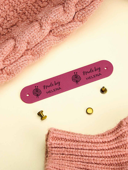 Handmade accessory with a sewn-on personalised PVC label — elegant craft branding