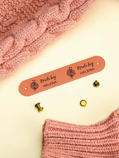 Close-up of custom PVC label edge and engraving detail on a personalised tag
