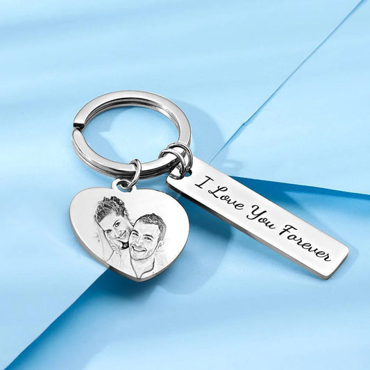 Engraved stainless steel personalised keyring displayed on flat surface showing front and back options, perfect for graduations or housewarmings