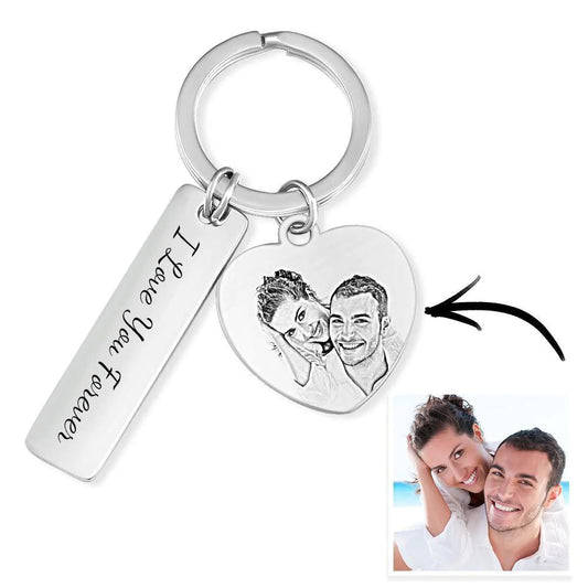 Engraved stainless steel personalised keyring displayed on flat surface showing front and back options, perfect for graduations or housewarmings