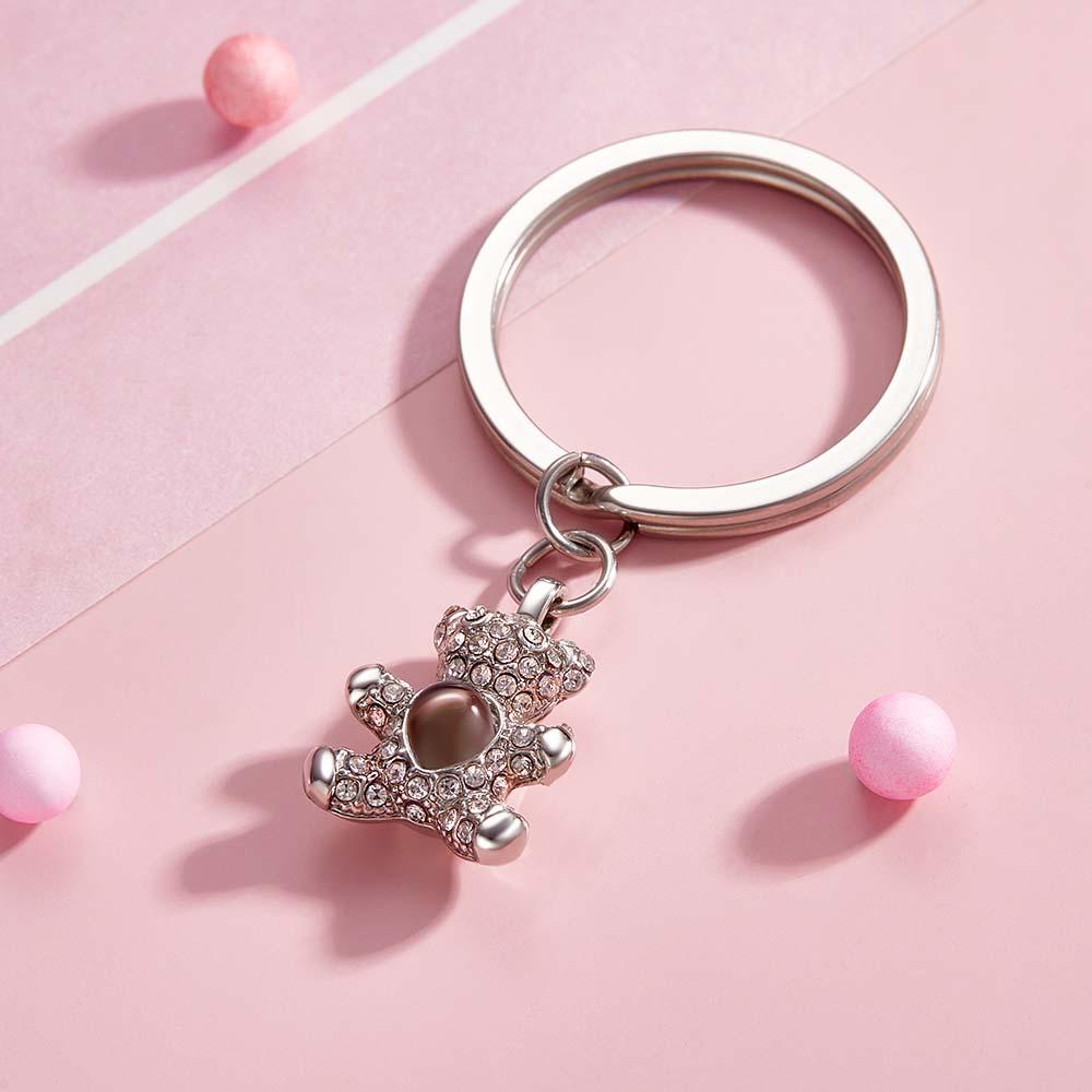Close-up of personalised bear photo projection keychain showing the photo window and metal key ring — bespoke custom bear gift for loved ones