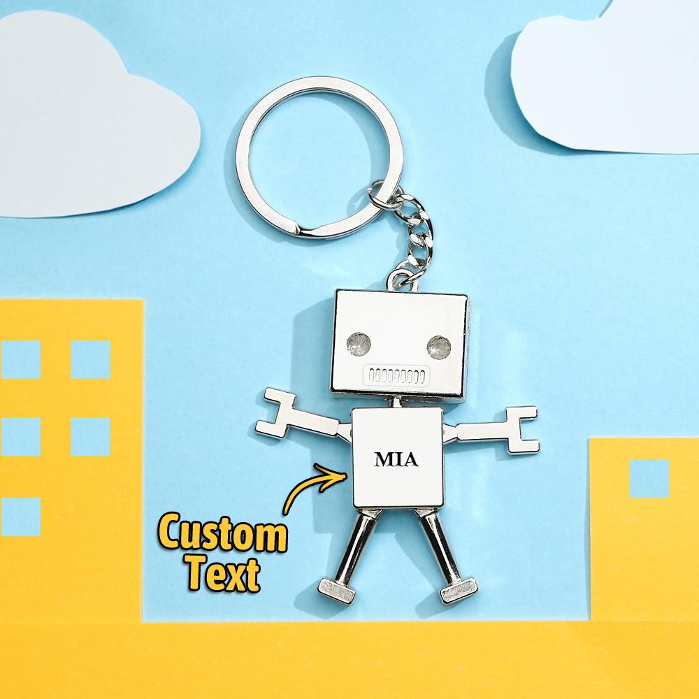 Personalised robot charm keyring close-up showing engraved custom text on metal — custom photo keychain and funny gift keepsake