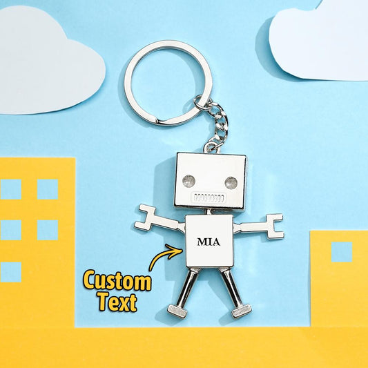 Personalised robot charm keyring close-up showing engraved custom text on metal — custom photo keychain and funny gift keepsake