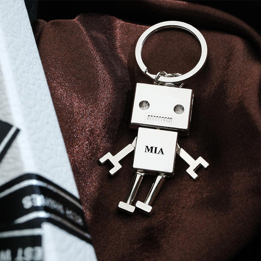 Personalised robot charm keyring close-up showing engraved custom text on metal — custom photo keychain and funny gift keepsake