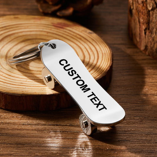 Personalised skateboard keyring close-up — custom engraved stainless steel mini skate deck keychain with realistic deck and wheel detail, ideal for skaters and skateboard lovers