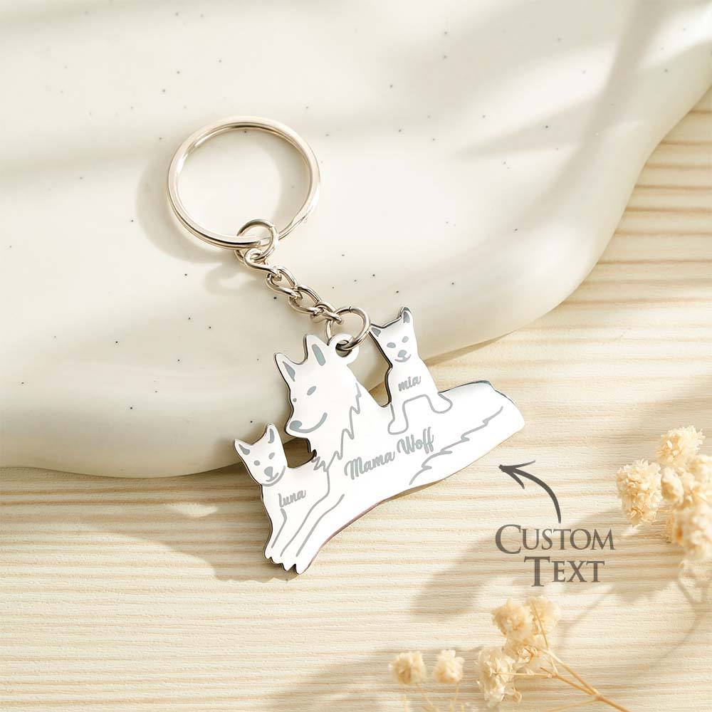 Macro of crisp personalised engraving on a wolf silhouette pendant — custom name keychain, high‑quality engraved family keepsake