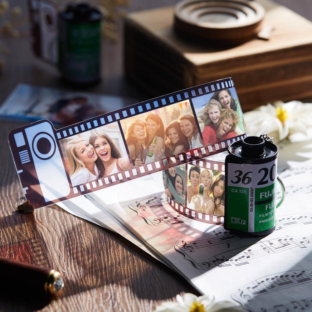 Close-up of the film-roll keyring showing printed photos and a sturdy keyring.