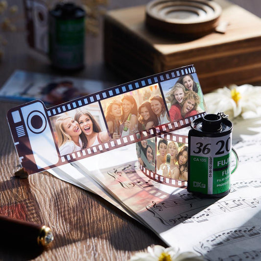 Close-up of the film-roll keyring showing printed photos and a sturdy keyring.