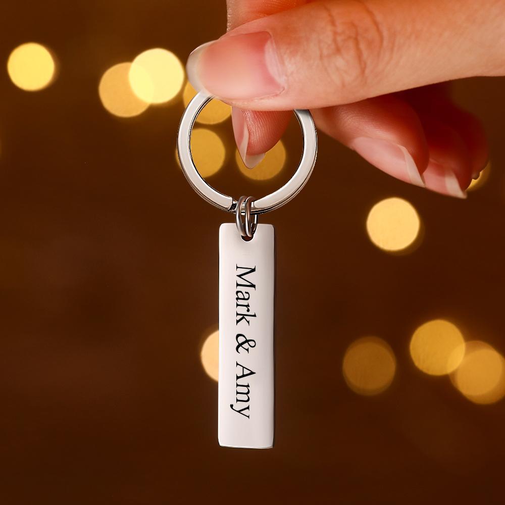 Close-up of engraved name and QR code on stainless steel personalised audio keychain — durable, long-lasting engraving