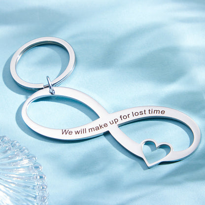 Angled view of hollow-out personalised infinity keyring highlighting engraving and attachment loop for keys or bags