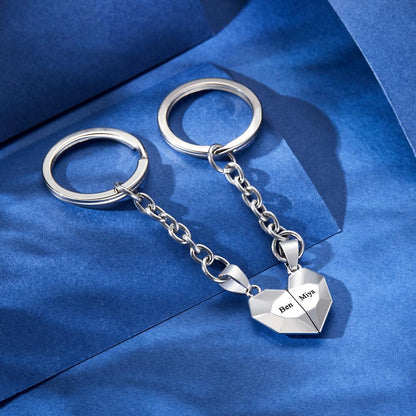 Lifestyle image of personalised engraved magnetic matching heart keychains attached to keys and a bag — practical yet sentimental anniversary gift for couples