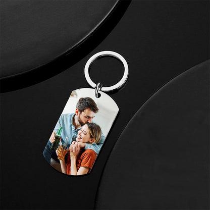 Personalised photo keyring attached to a handbag as a personalised bag charm and keepsake