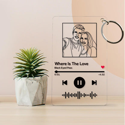 Personalised music code keychain attached to keys and a bag — engraved acrylic plaque with photo and song code keepsake