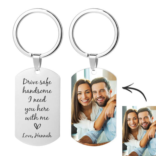 Two-sided aluminium personalised keyring showing a custom photo and name, engraved with ‘Drive safe dad I need you here with me’ — perfect personalised keyring, custom photo keyring, drive safe keychain and engraved dad keepsake