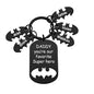 Personalised name keyring shown to scale on a table to illustrate size of the stainless steel tag
