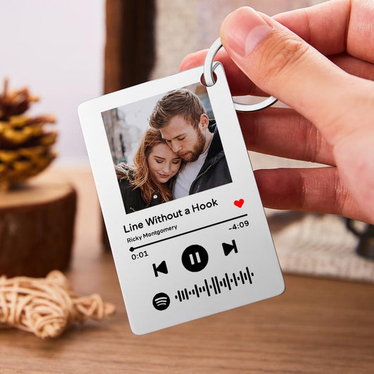 Personalised Spotify Code Keychain with engraved photo and song details on stainless steel plaque, close-up of scannable code