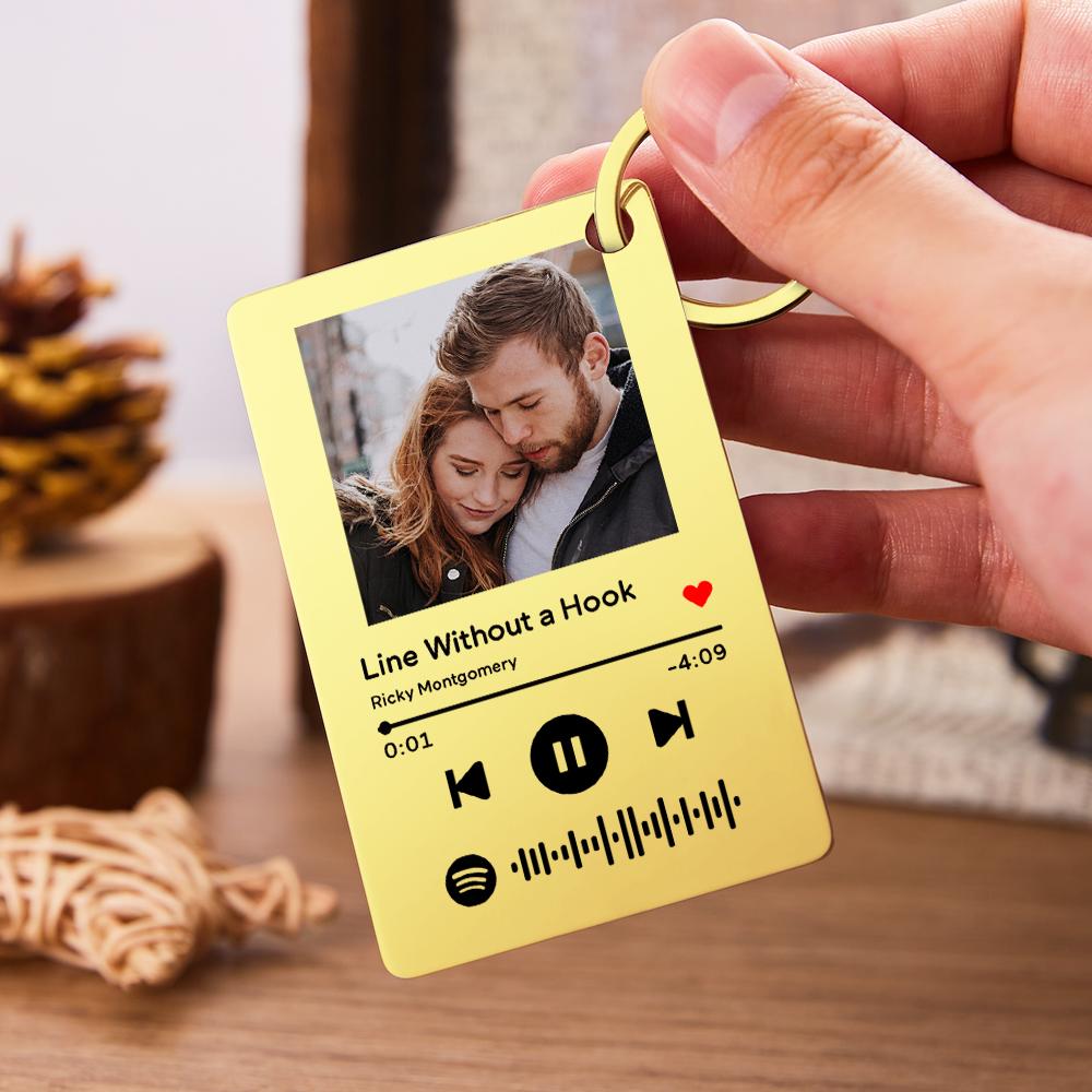 Close-up of scannable Spotify code and photo engraving on stainless steel keychain — personalised music gift idea