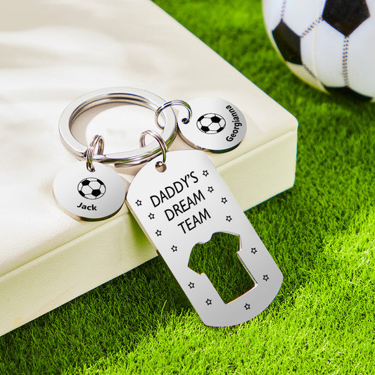Close-up of stainless steel personalised engraved football keyring reading 'Daddy's Dream Team' with children's name bars – Father's Day gift