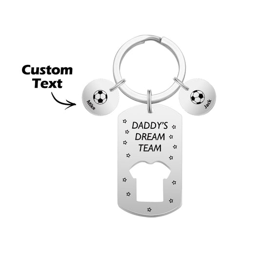 Close-up of stainless steel personalised engraved football keyring reading 'Daddy's Dream Team' with children's name bars – Father's Day gift