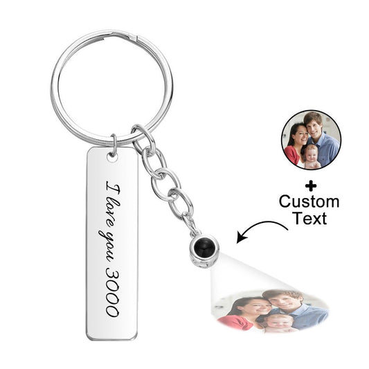 Close up of personalised projection keyring showing compact projection ball and custom engraving I Love You 3000, personalised photo gift for Dad or daughter