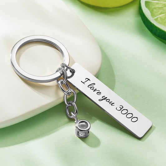 Close up of personalised projection keyring showing compact projection ball and custom engraving I Love You 3000, personalised photo gift for Dad or daughter