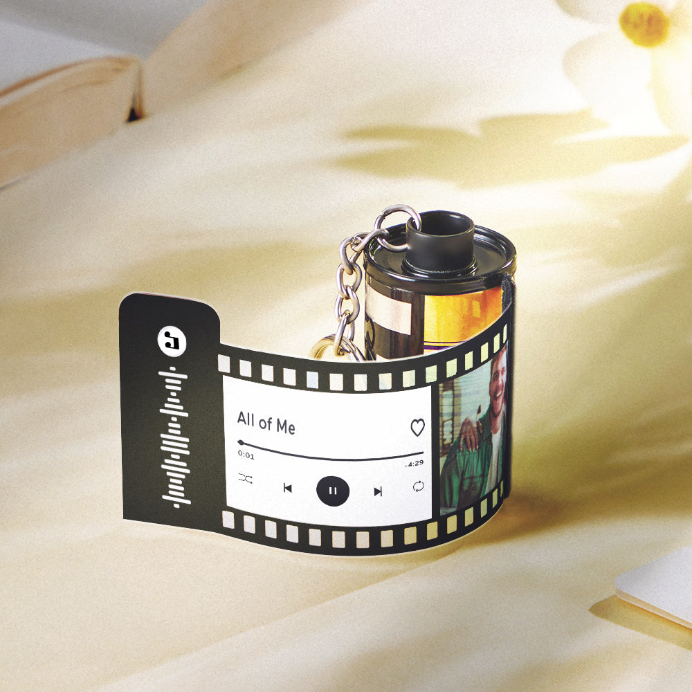 Close-up of personalised camera roll keychain with engraved name and date on durable recycled plastic — custom gift for Dad