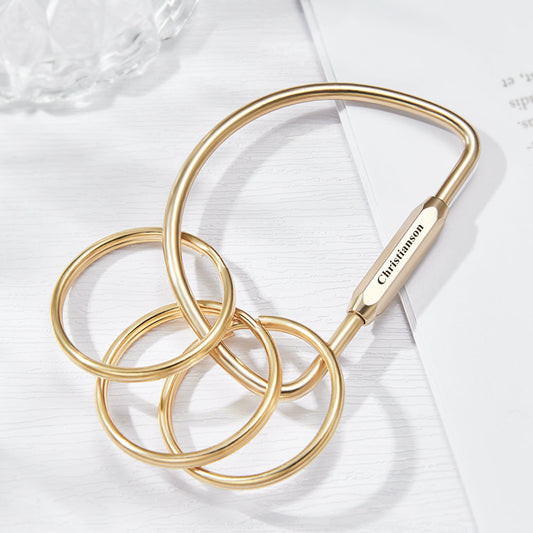 Personalised multi-layer brass-style keyring with custom engraved name on a layered charm and stainless steel ring — stylish personalised keychain gift.