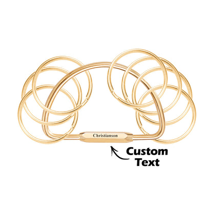 Personalised memorial keyring with multiple engraved names on layered brass-style discs — thoughtful engraved keyring for grandparents and loved ones.